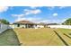 Wide backyard with a pizza oven, shed, green lawn, and white fence at 955 Hunters Meadow Ln, Lakeland, FL 33809