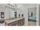 Granite countertops, dual sinks, and updated lighting fixtures make this bathroom shine at 955 Hunters Meadow Ln, Lakeland, FL 33809