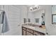 Stylish bathroom featuring a granite vanity top, a large mirror, and a white vessel sink at 955 Hunters Meadow Ln, Lakeland, FL 33809