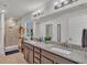 Granite countertops, dual sinks, and updated lighting fixtures make this bathroom shine at 955 Hunters Meadow Ln, Lakeland, FL 33809