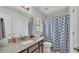 Well-maintained bathroom featuring granite vanity, a white sink, and a patterned shower curtain at 955 Hunters Meadow Ln, Lakeland, FL 33809