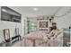 Comfortable bedroom featuring a tv, decorations, and a window providing natural light at 955 Hunters Meadow Ln, Lakeland, FL 33809