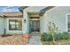 Inviting front entrance with decorative wreath, rock statue, and welcome decor at 955 Hunters Meadow Ln, Lakeland, FL 33809