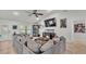 Cozy living room featuring a large sectional sofa, entertainment center, and natural light at 955 Hunters Meadow Ln, Lakeland, FL 33809