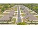 Aerial shot of a neighborhood lined with homes, green lawns, and symmetrical landscaping at 955 Hunters Meadow Ln, Lakeland, FL 33809