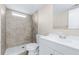 Updated bathroom with modern tiling in shower, white vanity, and new toilet at 1338 33Rd St Nw, Winter Haven, FL 33881