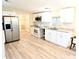 Bright kitchen features stainless steel appliances, white cabinets, granite counters, and modern flooring at 1338 33Rd St Nw, Winter Haven, FL 33881