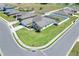 Aerial view of a suburban home with a spacious lawn, showcasing the neighborhood layout at 140 Heritage Park Ln, Mulberry, FL 33860