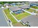 Aerial view of the fenced in backyard, pool, lanai, landscaping and surrounding neighborhood at 140 Heritage Park Ln, Mulberry, FL 33860