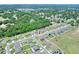 An elevated view of a neighborhood, with lush trees and greenery around the homes at 140 Heritage Park Ln, Mulberry, FL 33860