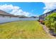 Spacious backyard features lush green grass, mature landscaping and secure fence at 140 Heritage Park Ln, Mulberry, FL 33860