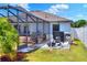 Well maintained backyard with screened-in patio with outdoor seating at 140 Heritage Park Ln, Mulberry, FL 33860