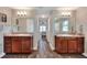 Bathroom with dual sinks, granite counters, and wood-look flooring at 140 Heritage Park Ln, Mulberry, FL 33860