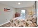 Bedroom with tropical bedding, wood-look floors, and natural light at 140 Heritage Park Ln, Mulberry, FL 33860