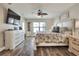 Bright bedroom featuring a large bed, ceiling fan, dresser, and natural light at 140 Heritage Park Ln, Mulberry, FL 33860