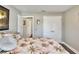 Neutral bedroom featuring a bed, closet doors, and ensuite bathroom access at 140 Heritage Park Ln, Mulberry, FL 33860