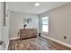 Bedroom with wood-look flooring, a dresser, and natural light at 140 Heritage Park Ln, Mulberry, FL 33860