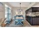 Inviting dining room with blue chairs, unique chandelier, and built in saltwater aquarium at 140 Heritage Park Ln, Mulberry, FL 33860