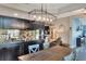 Dining area featuring custom light fixtures and a view into the living room and office at 140 Heritage Park Ln, Mulberry, FL 33860