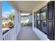 Welcoming front porch with white railings, dark shutters and trim and shade trees at 140 Heritage Park Ln, Mulberry, FL 33860