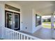 Covered front porch with view of the glass paneled entry door and exterior architectural details at 140 Heritage Park Ln, Mulberry, FL 33860
