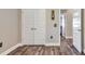 Hallway featuring wood-look tile floors, white doors, and unique switch plate covers at 140 Heritage Park Ln, Mulberry, FL 33860