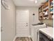 Functional laundry room with a modern washer and dryer and open shelving for storage at 140 Heritage Park Ln, Mulberry, FL 33860