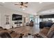 Spacious living room featuring hardwood floors, entertainment center, and comfortable seating at 140 Heritage Park Ln, Mulberry, FL 33860