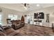 Cozy living room with comfortable seating, wood-look floors, and a large TV at 140 Heritage Park Ln, Mulberry, FL 33860