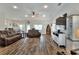 Bright living room with wood-look floors, neutral color scheme, and comfortable seating at 140 Heritage Park Ln, Mulberry, FL 33860