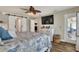 Spacious main bedroom featuring a bed, dresser, TV and sliding barn doors at 140 Heritage Park Ln, Mulberry, FL 33860