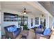 Relaxing covered patio area with wicker furniture, ceiling fans, and view of the pool at 140 Heritage Park Ln, Mulberry, FL 33860