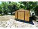 Spacious backyard featuring a storage shed and large trees offering ample shade at 1618 Crystalview Trl, Lakeland, FL 33801