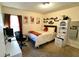Bedroom with modern decor, featuring a comfy bed, desk, and ample shelf space at 1618 Crystalview Trl, Lakeland, FL 33801