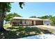 Charming single-story home with well-maintained landscaping and a metal roof at 1618 Crystalview Trl, Lakeland, FL 33801