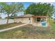 Backyard view featuring a patio, detached structure, and well-kept lawn at 202 Saint Lucie Rd, Winter Haven, FL 33884