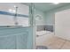 Bathroom featuring a bathtub, walk-in shower with blue tiled accents, and a double door closet at 202 Saint Lucie Rd, Winter Haven, FL 33884