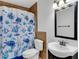 Bathroom featuring a shower with a turtle themed curtain, a toilet and vanity at 202 Saint Lucie Rd, Winter Haven, FL 33884