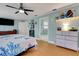 Spacious bedroom featuring a ceiling fan, modern furniture, and an ensuite bathroom at 202 Saint Lucie Rd, Winter Haven, FL 33884