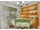 Charming dining area with a vintage-style table and built-in shelving for decor at 202 Saint Lucie Rd, Winter Haven, FL 33884