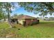 Exterior view of the property featuring a well-maintained yard and a glimpse of the screened-in lanai at 202 Saint Lucie Rd, Winter Haven, FL 33884