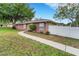 Quaint brick home featuring a tidy lawn and a walkway at 202 Saint Lucie Rd, Winter Haven, FL 33884
