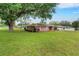 Spacious brick house with lush green lawn, mature trees, and a two-car garage at 202 Saint Lucie Rd, Winter Haven, FL 33884