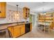 Bright kitchen with tile floor, light wood cabinets, and a cozy dining area for easy meals at 202 Saint Lucie Rd, Winter Haven, FL 33884