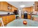 Open kitchen area with wood cabinetry, black appliances, and a dining table in the center at 202 Saint Lucie Rd, Winter Haven, FL 33884