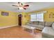 Bright living room with wood floors, a comfortable couch, and a large window, perfect for relaxation at 202 Saint Lucie Rd, Winter Haven, FL 33884