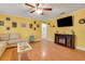 Inviting living room with entertainment center, wooden floors, and a beige sofa at 202 Saint Lucie Rd, Winter Haven, FL 33884