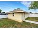 Exterior view of outbuilding with sidewalk access, exterior lighting, and white fence in background at 202 Saint Lucie Rd, Winter Haven, FL 33884