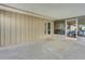 Covered patio with a door into the home and screened lanai entrance at 202 Saint Lucie Rd, Winter Haven, FL 33884