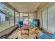 Enclosed porch featuring comfortable seating, perfect for relaxation and enjoying the outdoors at 202 Saint Lucie Rd, Winter Haven, FL 33884
